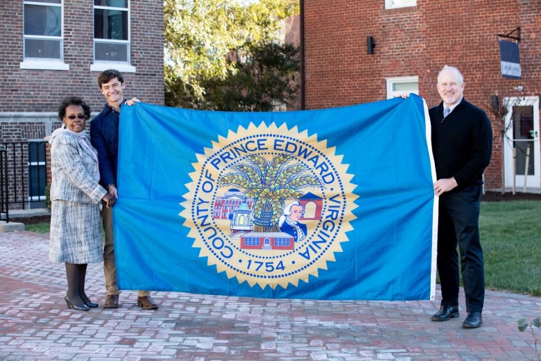 The new Prince Edward County flag. From left: Board of Supervisors Chair, Odessa H. Pride, E. Harrison Jones, Supervisor, District 1 (Farmville), and Douglas P. Stanley, County Administrator. Courtesy of Prince Edward County.