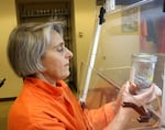 PSU scientists Elise Granek inspects lint collected at one of 90 Oregon households taking part in her team's microplastics research, Nov. 5, 2025.
