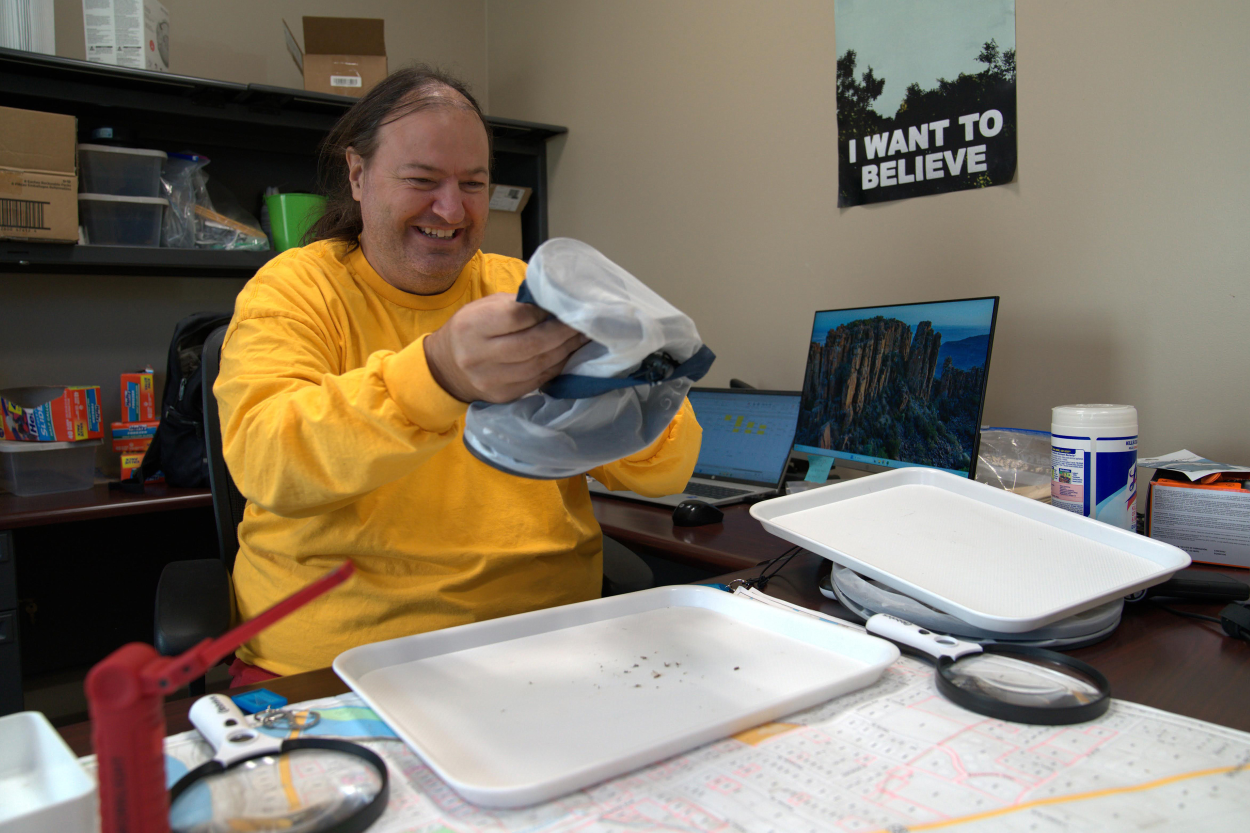 David Garrett empties a mosquito trap in his Grand Junction office to count how many invasive mosquitoes were caught.