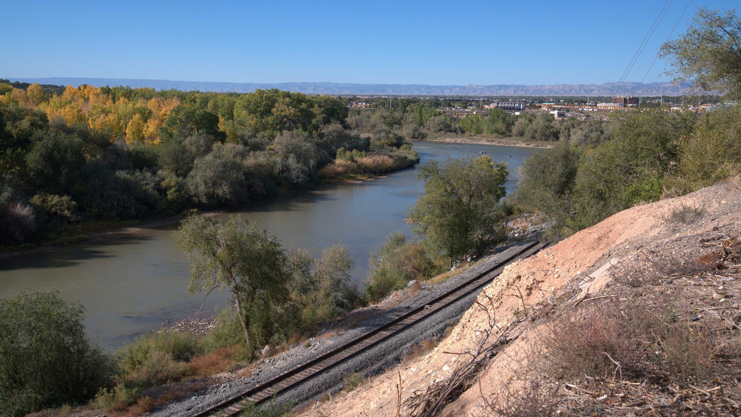 The Gunnison River is seen just before it meets the Colorado River in Grand Junction, Colo. An invasive species of mosquito that can carry the dengue virus, the Aedes aegypti, was discovered in the Orchard Mesa neighborhood just east of the river junction.