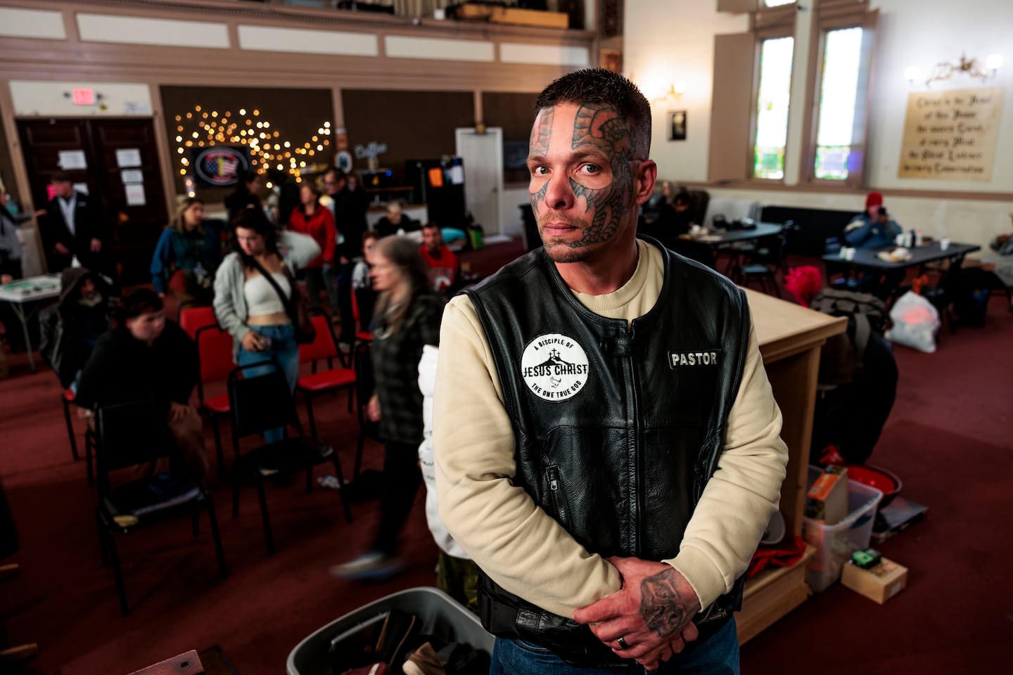 Pastor Brandon posed for a portrait as visitors awaited their turn to shop for free at the storehouse inside the Brick Church. Brandon is helping lead the church’s operation to provide free services to those in need amid the largest HIV outbreak in Maine history.