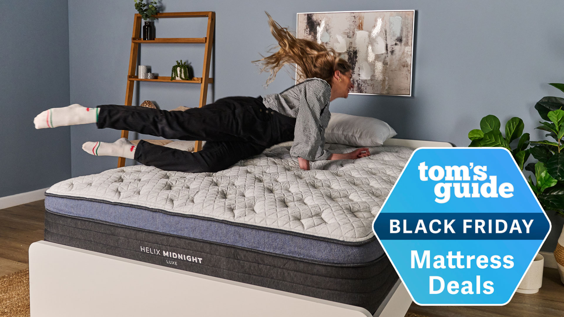 The Tom's Guide Sleep Editor jumping on a Helix mattress with a Tom's Guide Black Friday Mattress Deals badge overlaid