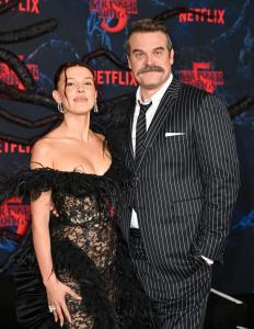 Millie Bobby Brown and David Harbour at the "Stranger Things" Season 5 World Premiere held at the TCL Chinese Theatre on November 06, 2025 in Los Angeles, California.