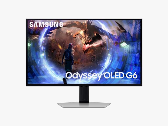 Black desktop monitor with silver screen as screen shows a scene from a game