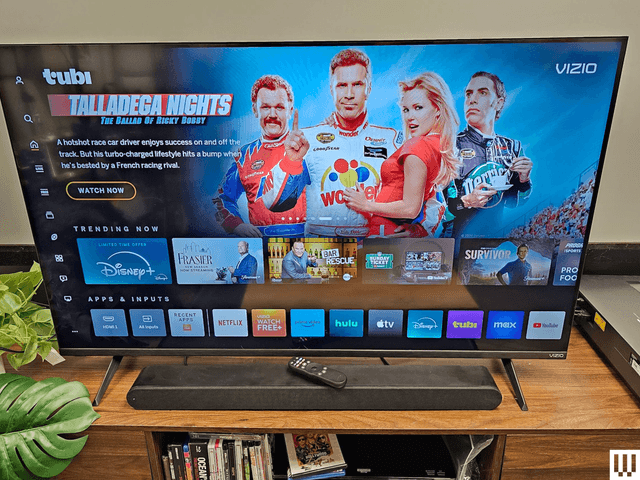 Front view of large lat screen tv with the screen showing previews of video content