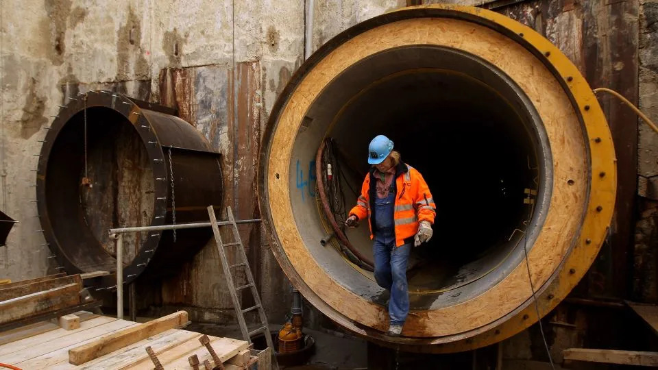 A worker emerges from the entrance to a pipeline on April 8, 2010 near Lubmin, Germany. - Sean Gallup/Getty Images