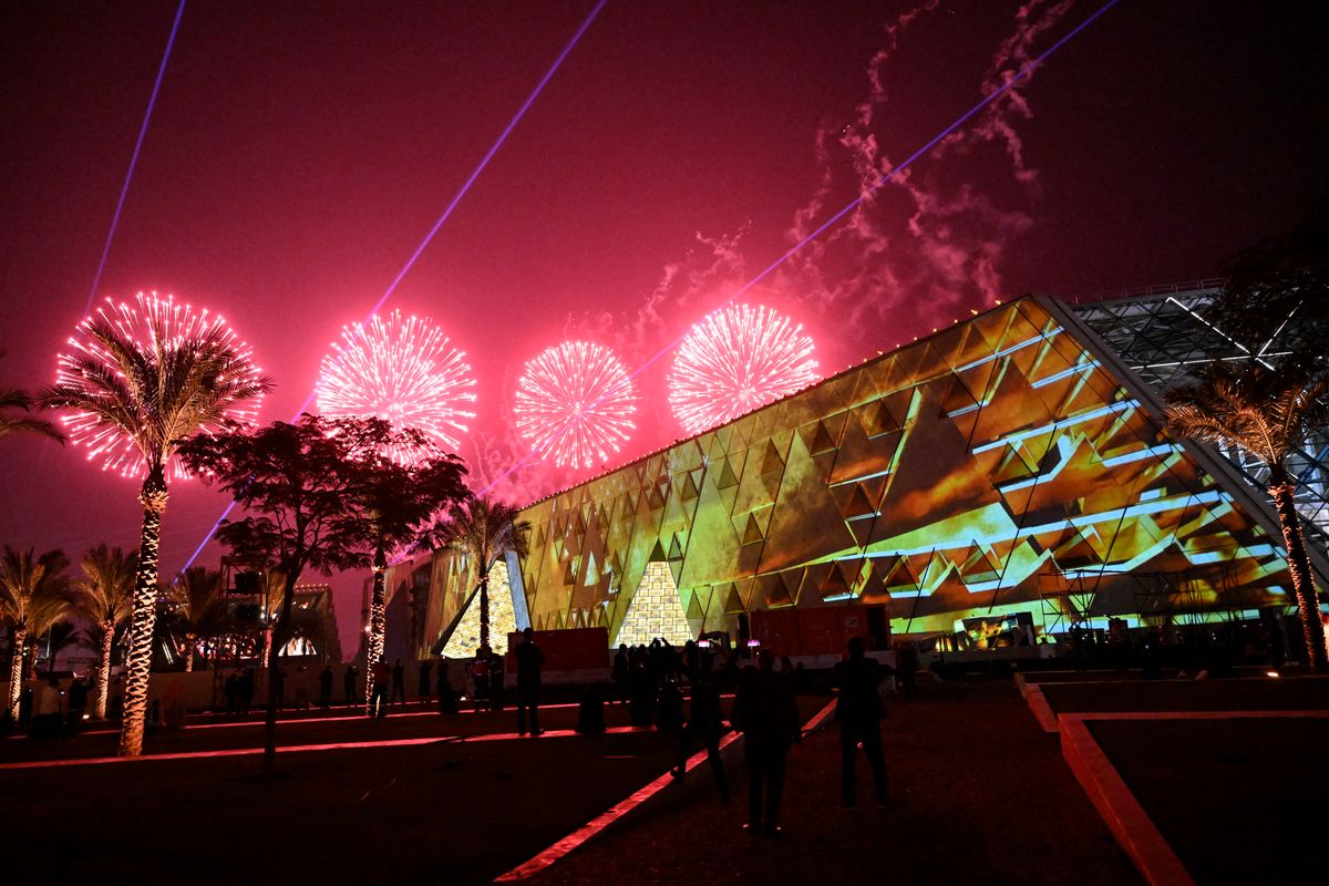 TOPSHOT - Fireworks light up the sky during the opening ceremony of the Grand Egyptian Museum (GEM) in Giza, on the southwestern outskirts of the capital Cairo on November 1, 2025. Near the ancient Pyramids of Giza just outside Cairo, the Grand Egyptian Museum is gearing up for a lavish opening on November 1, after two decades of delays. Massive statues and historic artefacts from the country's ancient civilisation will be on display across the 24,000 square metres (258,000 square feet) of permanent exhibition space. (Photo by Khaled DESOUKI / AFP) (Photo by KHALED DESOUKI/AFP via Getty Images)          