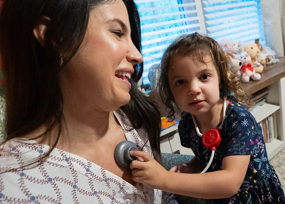 Christy Houvouras plays doctors with her 3-year-old daughter at her home in Huntington, West Virginia.