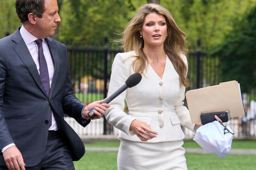Lindsey Halligan speaks with a reporter outside of the White House on August 20.