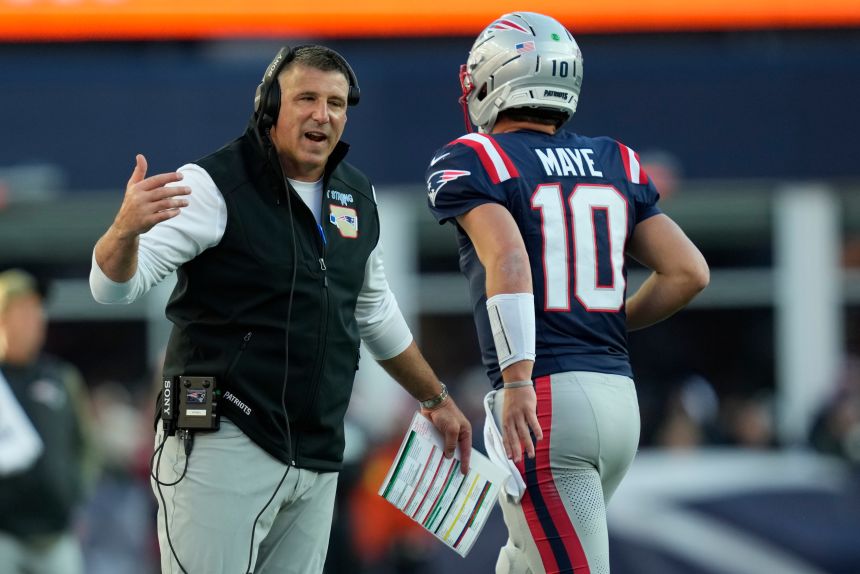 New England Patriots head coach Mike Vrabel speaks with quarterback Drake Maye during their game against Atlanta on Sunday.