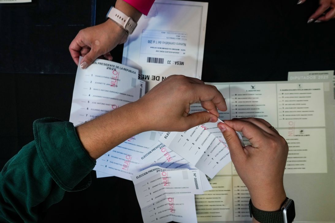 An electoral worker prepares demonstration ballots inside the old Mapocho train station that is now a cultural center to be used as a polling station for the general election in Santiago, Chile, on November 14.