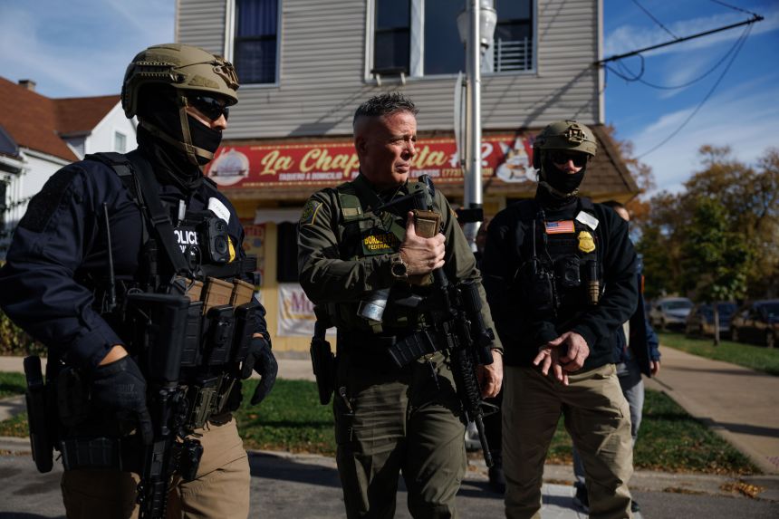 Border Patrol Official Gregory Bovino, center, walks with other agents while conducting an immigration enforcement sweep in Chicago's Brighton Park neighborhood on November 6.