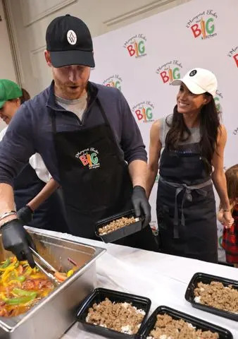 Eric Charbonneau for The Archewell Foundation Prince Harry and Meghan Markle dish out meals for food insecure members of the community at Our Big Kitchen Los Angeles (OBKLA)
