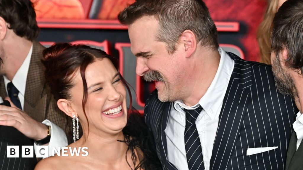  Millie Bobby Brown and David Harbour embrace at Stranger Things premiere