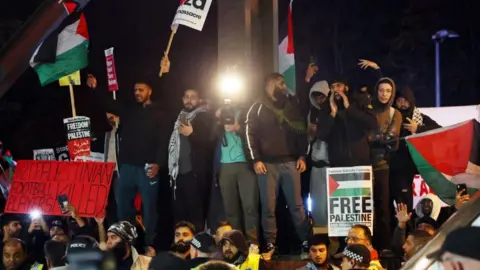 Reuters A group of pro-Palestine protesters gather with a range of banners and flags, close to Villa Park.