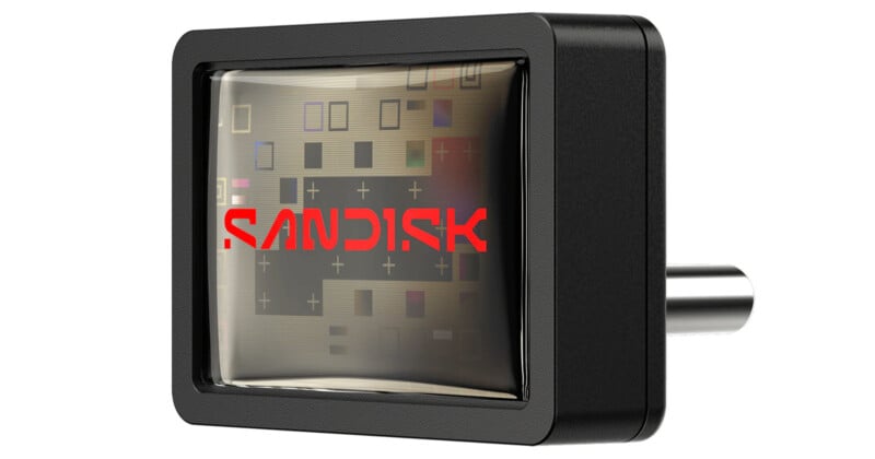 A close-up of a black SanDisk device with the red SanDisk logo on a reflective surface, showing an intricate pattern of circuitry and connectors inside.