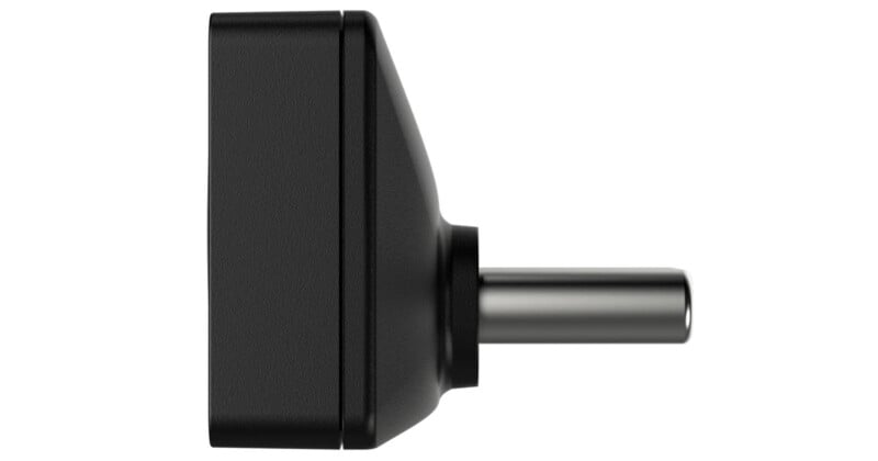 A black, rectangular DC power adapter plug shown from the side, displaying the cylindrical metal connector extending outward.
