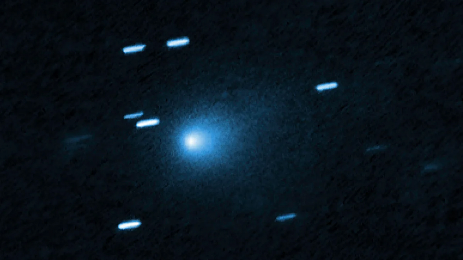 Hubble image of 3I/ATLAS. White dashes on a black background.