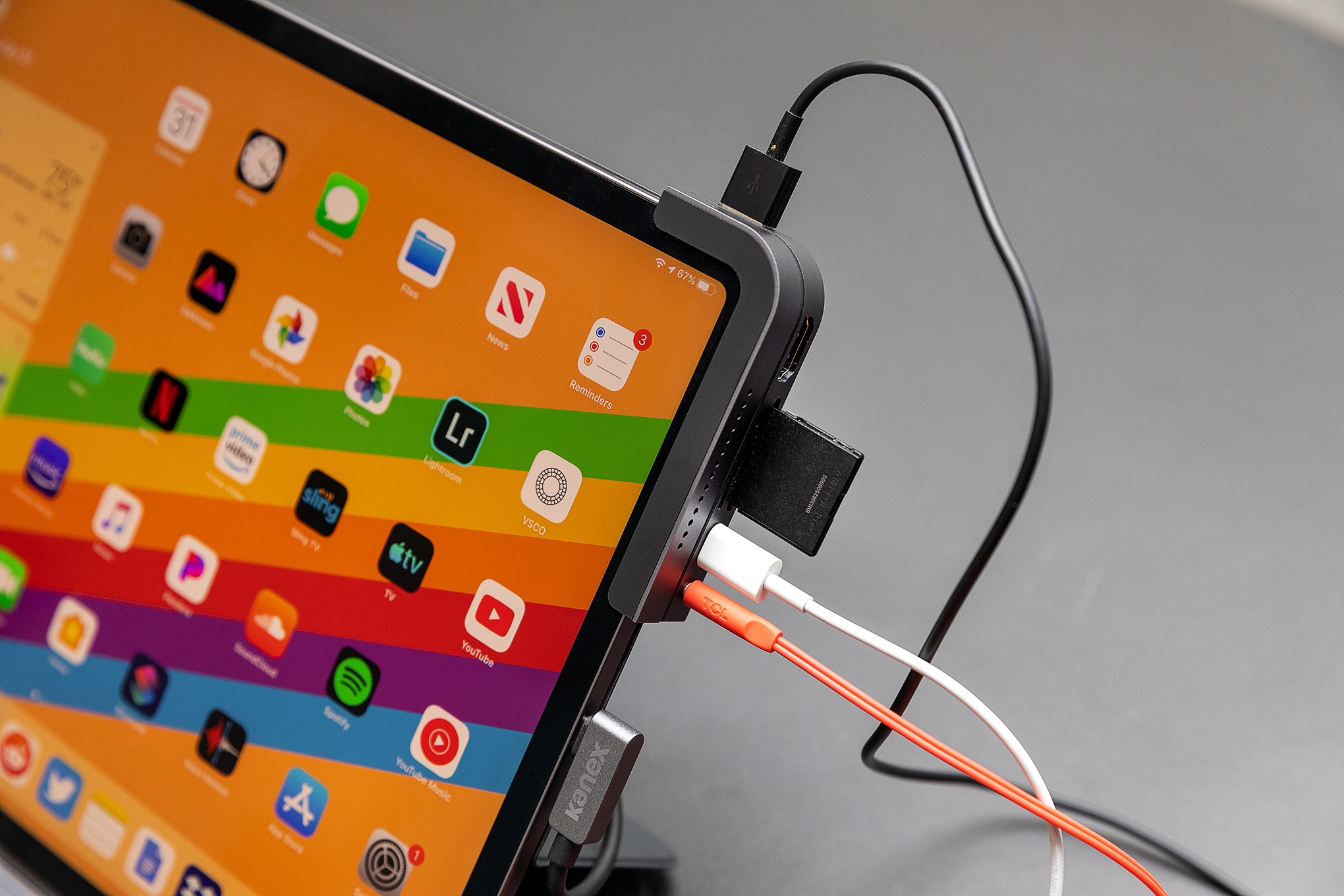 An iPad Pro, with a bunch of dongles hanging off the side.