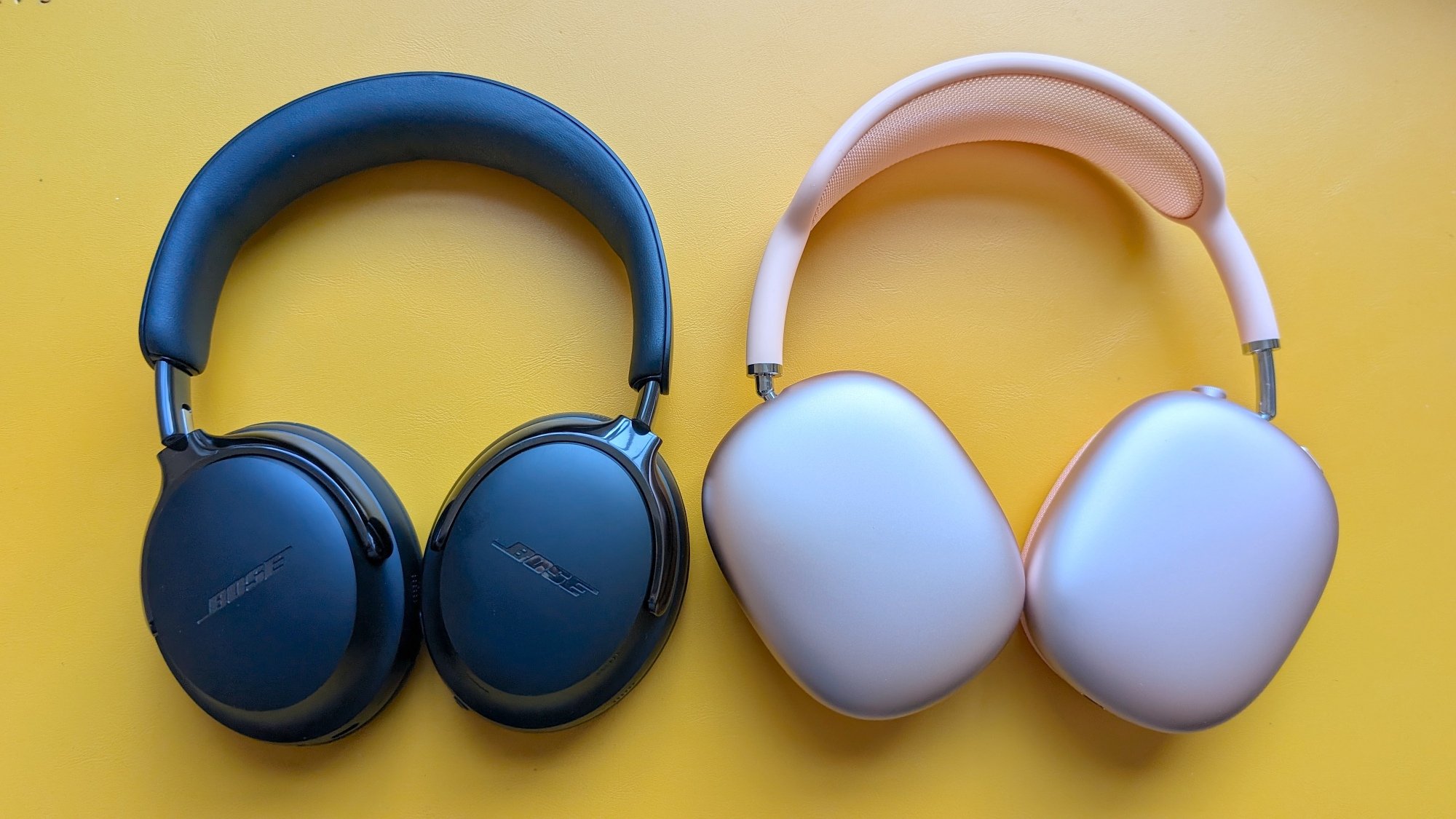 The Bose QC Ultra (Gen 2) headphones next to the Apple AirPods Max on a yellow background.