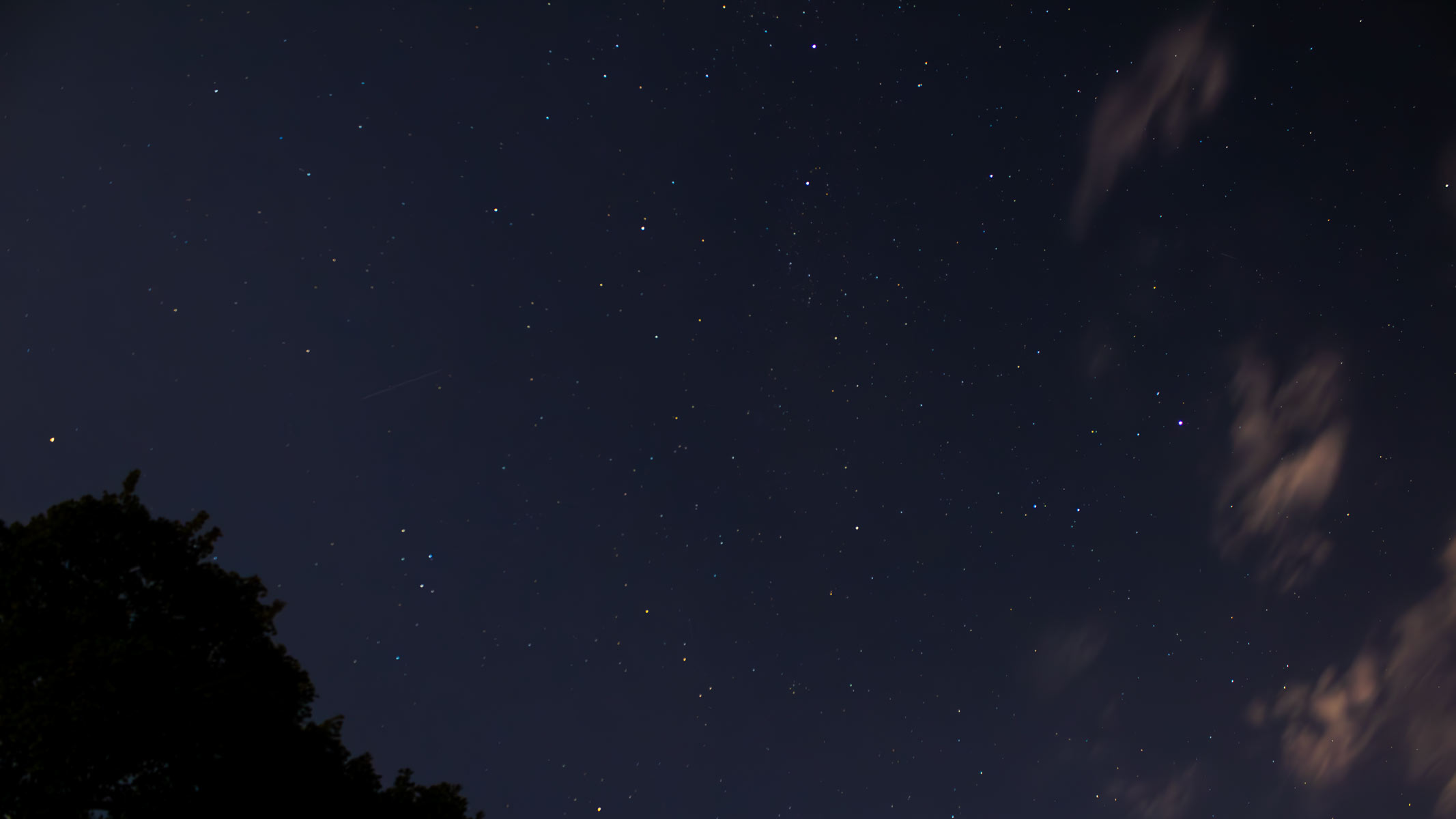 The Northern Cross asterism in Cygnus constellation with Delphinus and Sagitta constellations in the starry night sky.