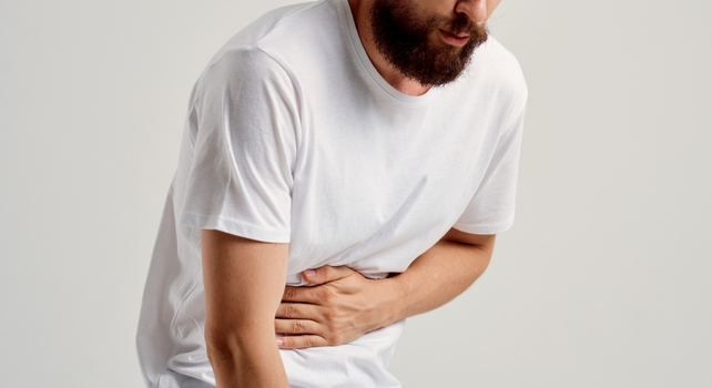 man with stomach cramps