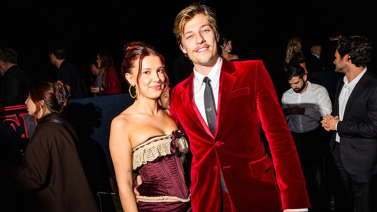 Millie Bobby Brown poses with her husband Jake Bongiovi at premiere