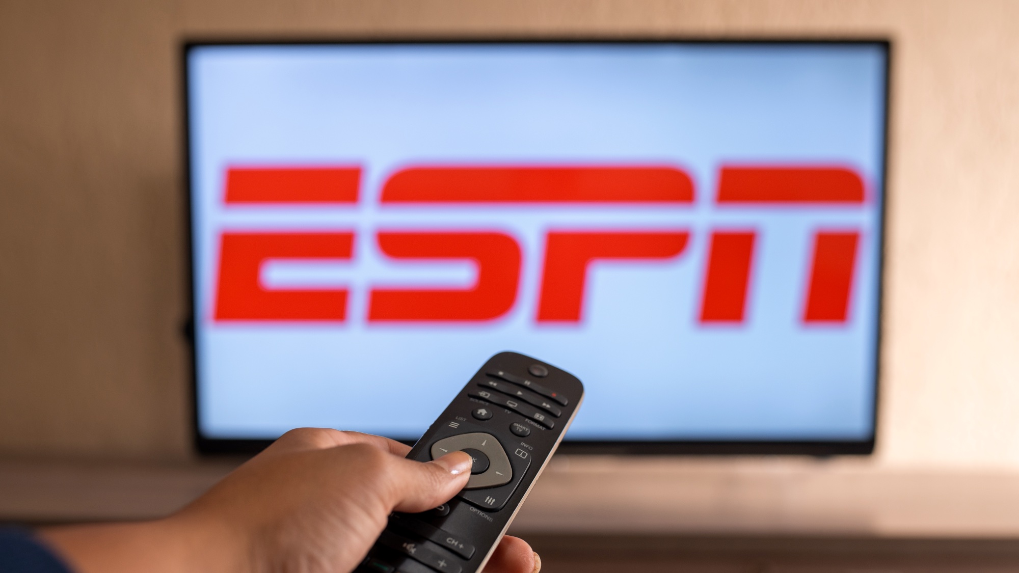 ESPN logo on TV with remote
