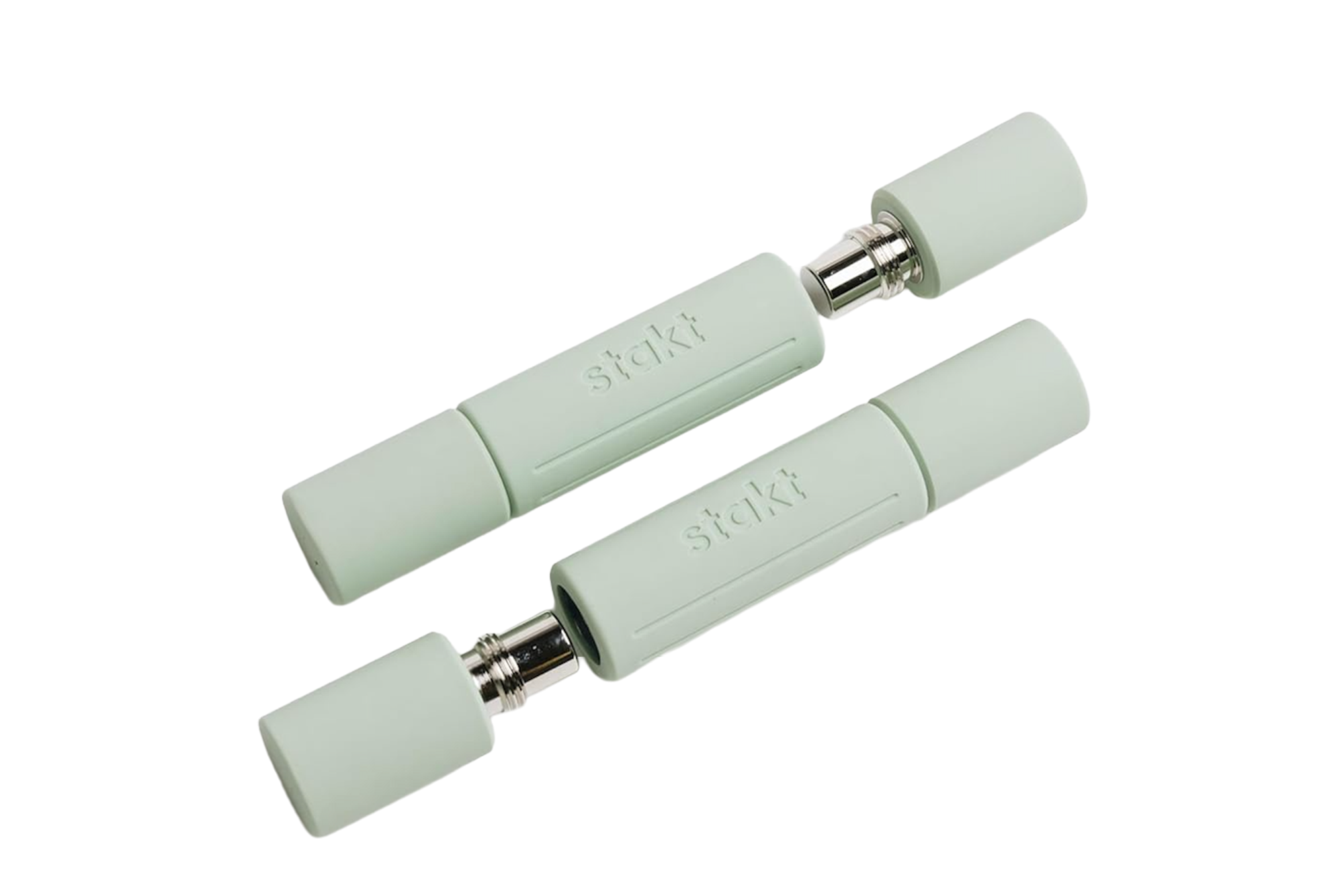Two light green Stakt fitness dumbbell handles with chrome ends, separated by a gap.
