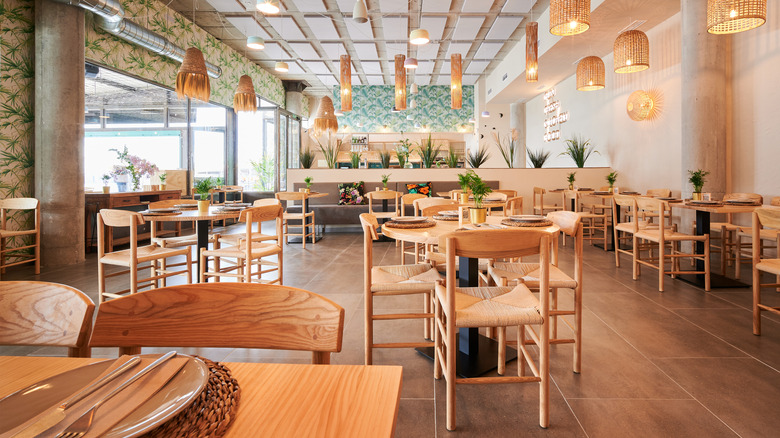 All of the tables and chairs are available in an empty restaurant