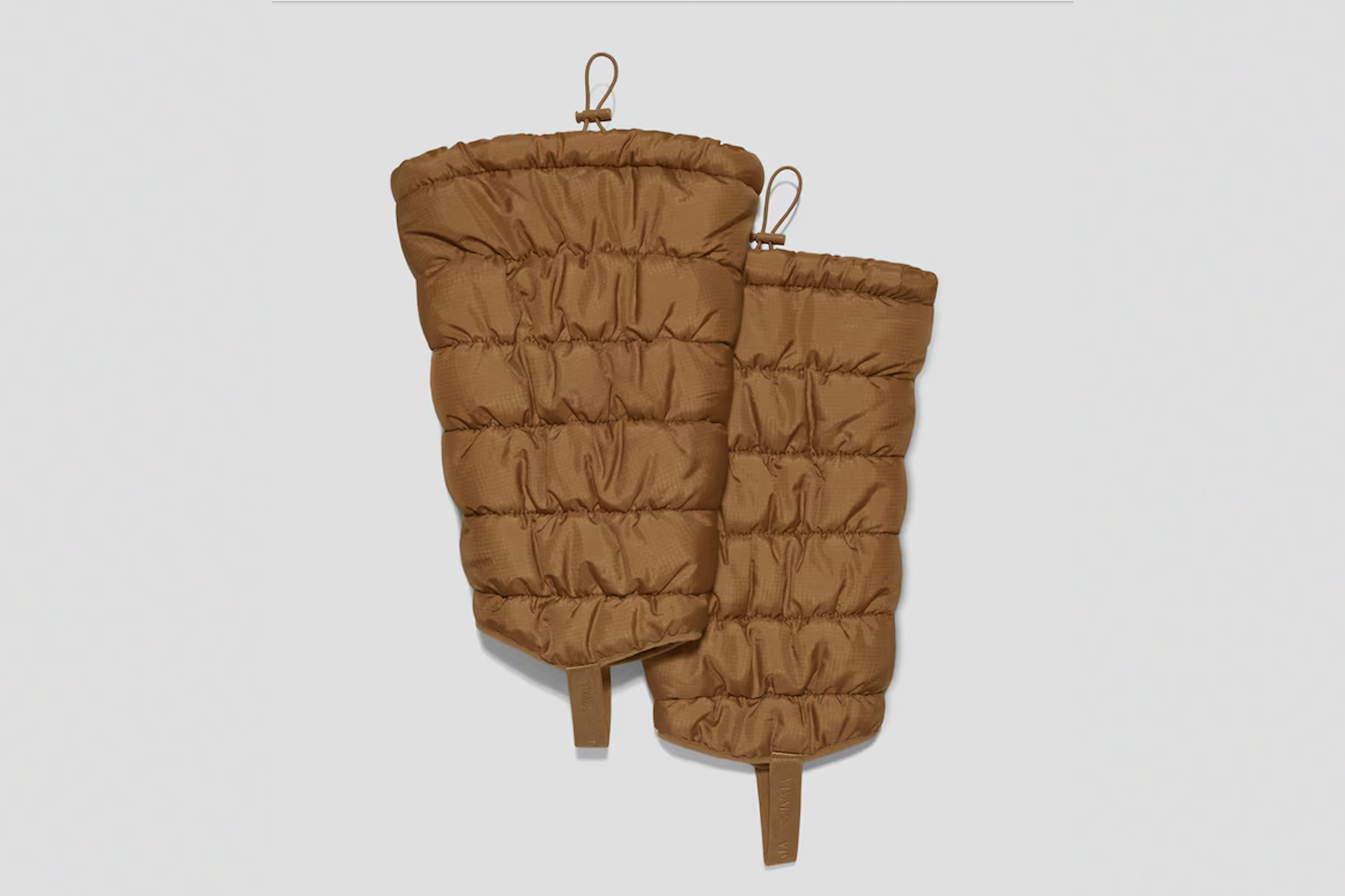 Pair of brown quilted leg warmers.