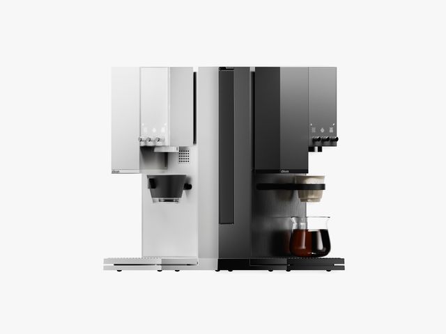 Two back-to-back coffee machines - white on the left and black on the right