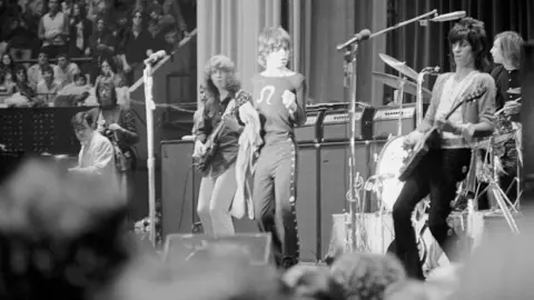 Getty Images Sir Mick Jagger wearing Price's buttoned trousers on tour in New York City in 1969.