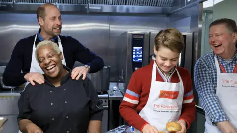 Andrew Parsons/Kensington Palace Prince William and Prince George helping prepare food at the Passage charity