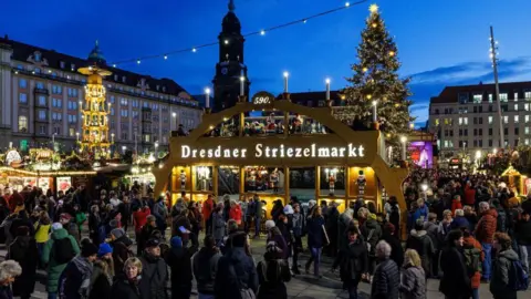 AFP via Getty Images People at Dresden's Christmas market