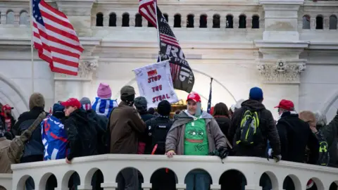 Getty Images A man seen wearing a Pepe shirt during the 6 January 2021 riot at Capitol Hill, where Trump supporters attempted to prevent his loss to Joe Biden
