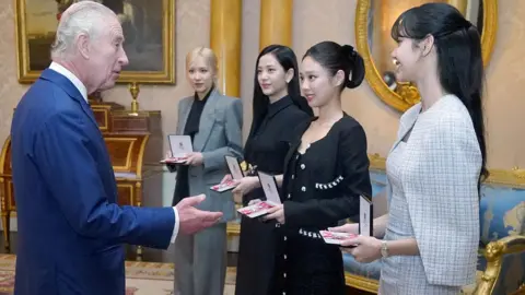 PA Media K-pop band Blackpink receiving honorary MBEs from King Charles in 2023. 
