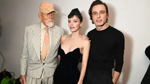 Getty Images Antony Price, Lily Allen and Marco Capaldo pose backstage at the 16Arlington x Antony Price Salon Show on 17 November 2025 in London, England.