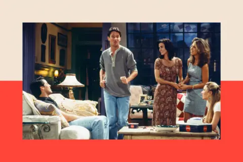 NBC Universal via Getty Images A still from the show Friends, with characters standing around in an apartment
