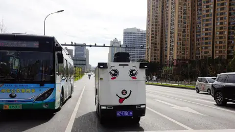 CFOTO/Future Publishing via Getty Images)  A ZELOS autonomous driving unmanned vehicle is driving on the street in Yichang, Hubei Province, China on November 20, 2025.