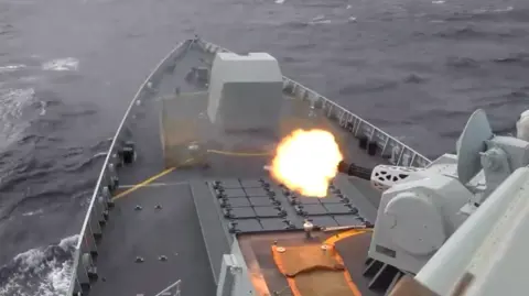 Eastern Theater Command View of the tip of a war ship as it fires towards the sea