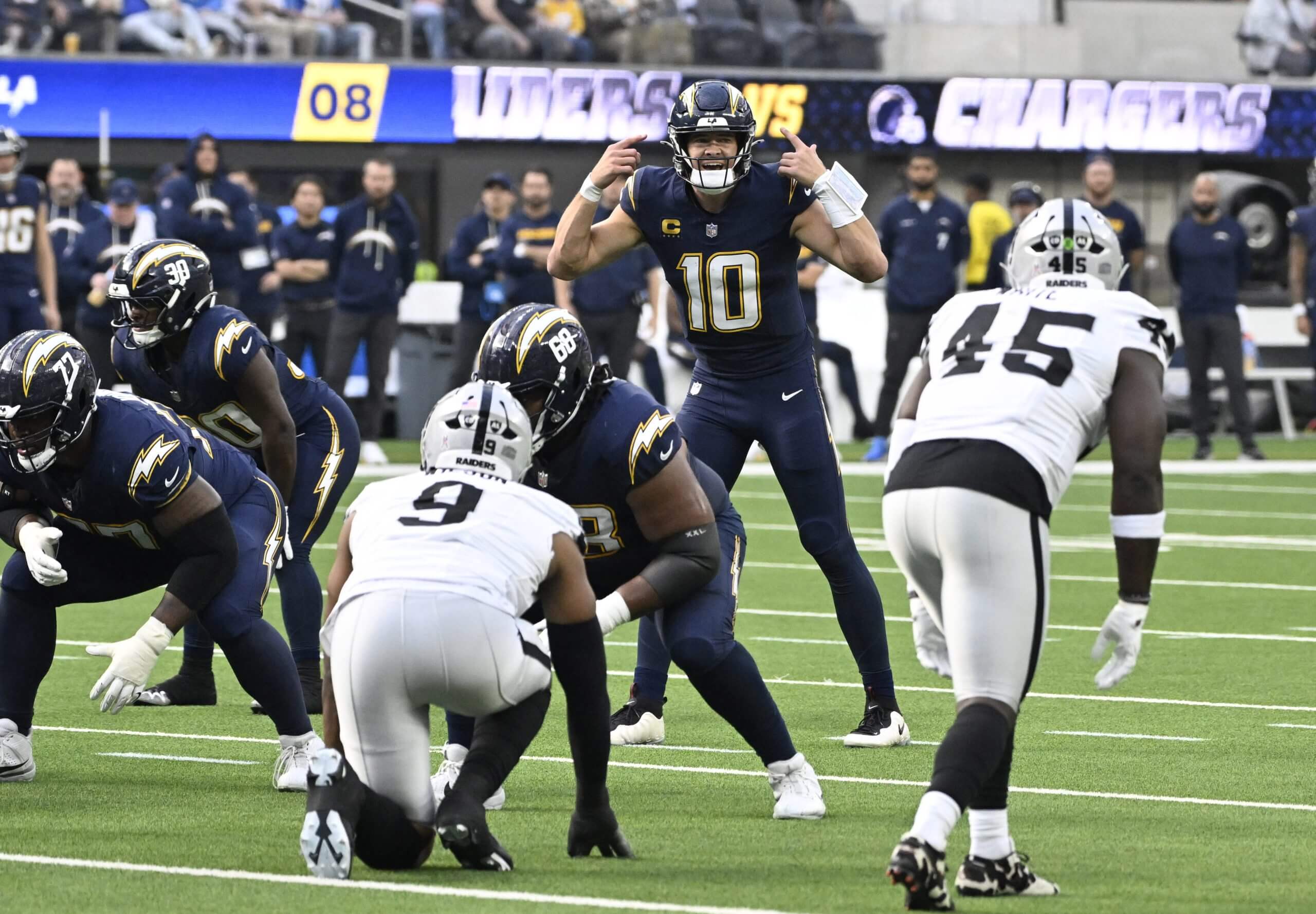 Quarterback Justin Herbert #10 of the Los Angeles Chargers against the Las Vegas Raiders in the first half of an NFL football game at SoFi Stadium in Inglewood on Sunday, November 30, 2025.