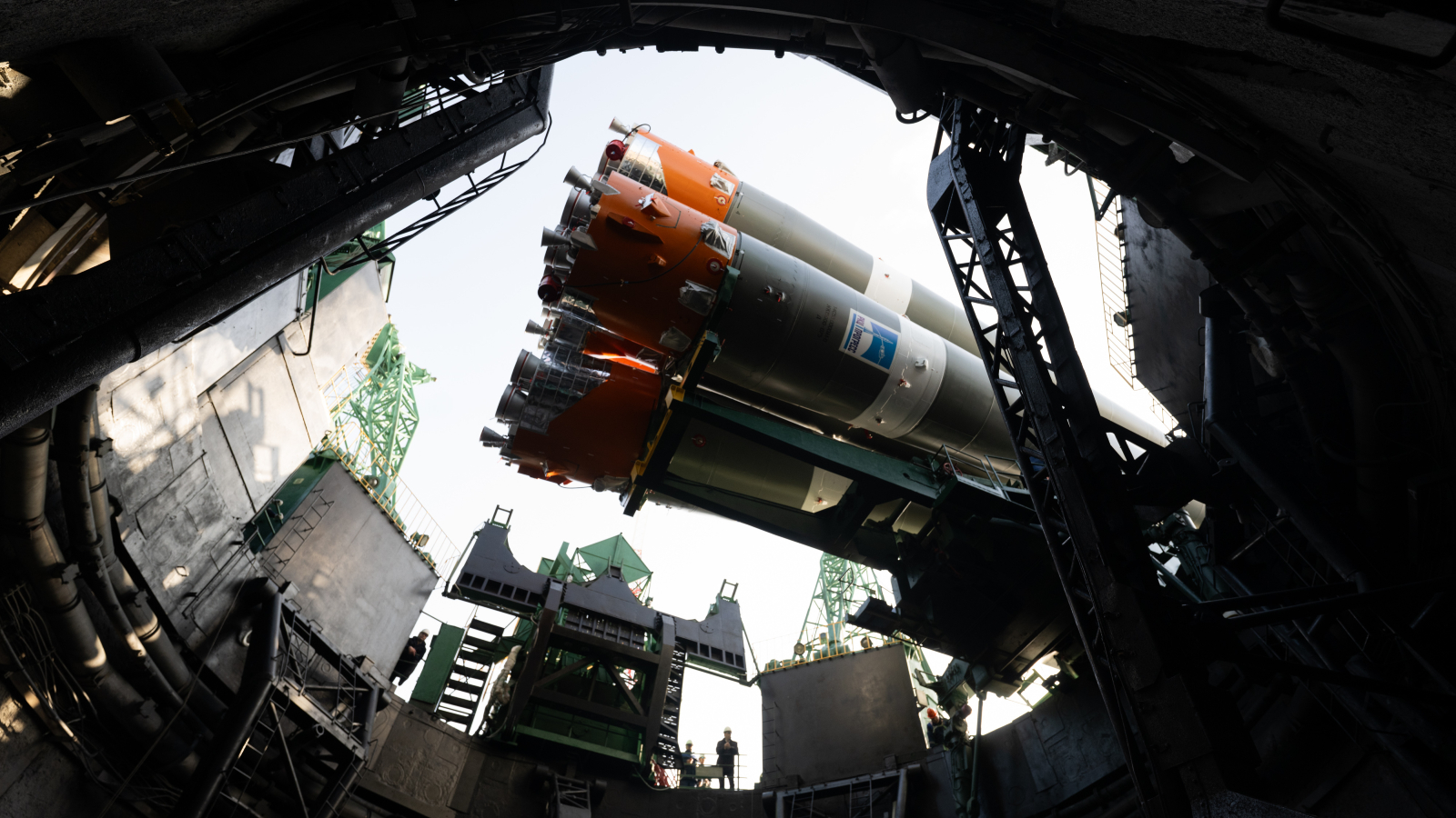 Photo taken from below the launch pad showing a Soyuz rocket being readied for launch