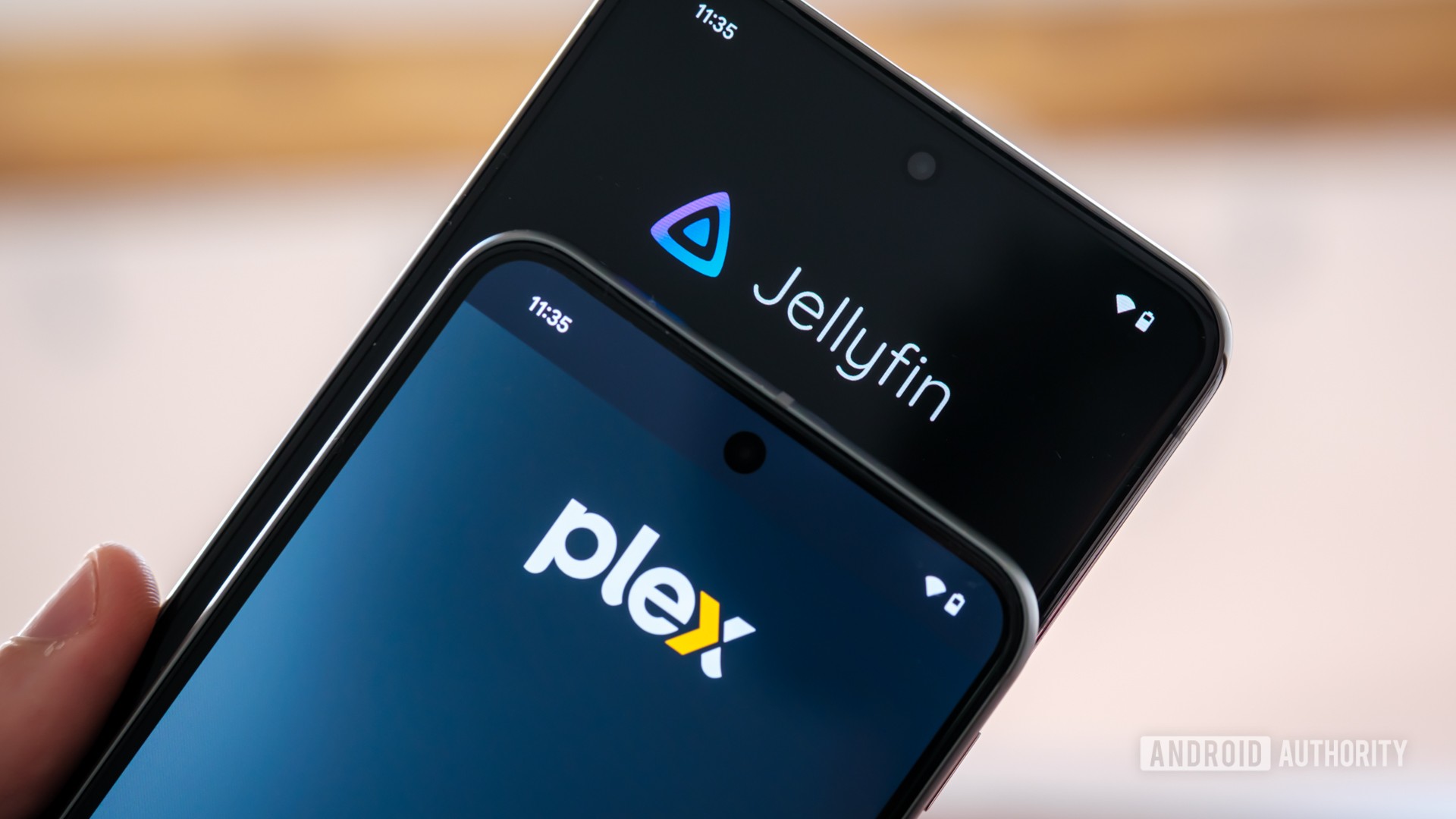 Plex vs Jellyfin logos angled Plex vs Jellyfin logos angled