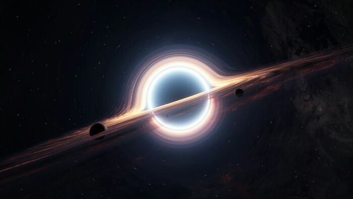 A glowing black hole in space with orbiting objects, illustrating mysterious cosmic phenomena people cannot solve.