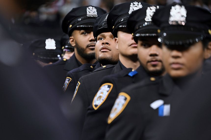 Newly commissioned New York City police officers attend a New York City Police Academy graduation ceremony at Madison Square Garden on August 6.