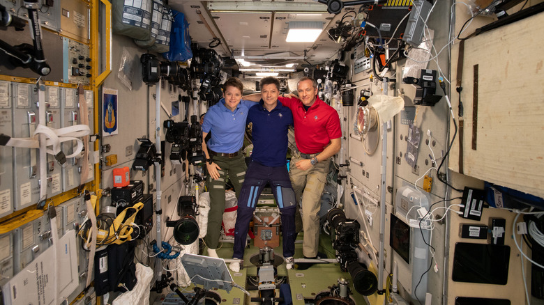Expedition 58 crew members gather inside the Zvezda service module for a crew portrait. From left are, NASA astronaut Anne McClain, Roscosmos cosmonaut Oleg Kononenko and Canadian Space Agency astronaut David Saint-Jacques.