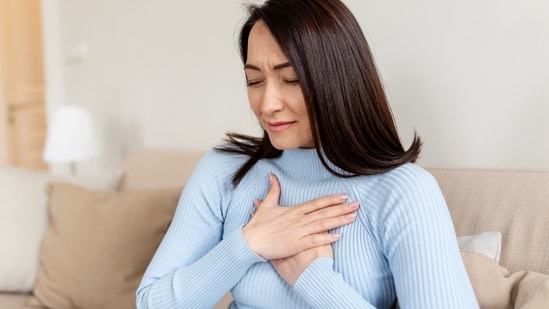 Chest pain is one of the warning signs. (Adobe Stock)