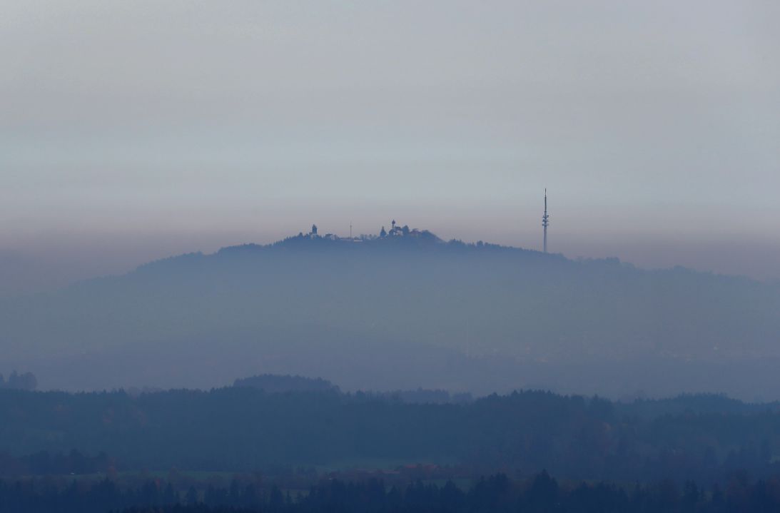 Hohenpeißenberg weather station with the pilgrimage church of the Assumption of the Virgin rises out of the fog on November 9, 2018.