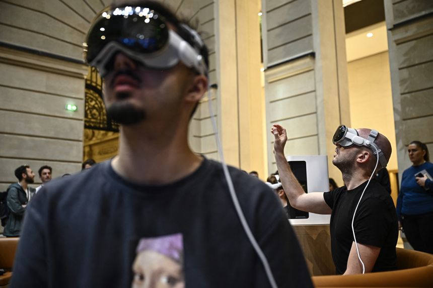 Customers try the Apple Vision Pro mixed reality glasses device by US company Apple Inc. during the launch at the Apple store on Champs Elysees avenue in Paris on July 12, 2024